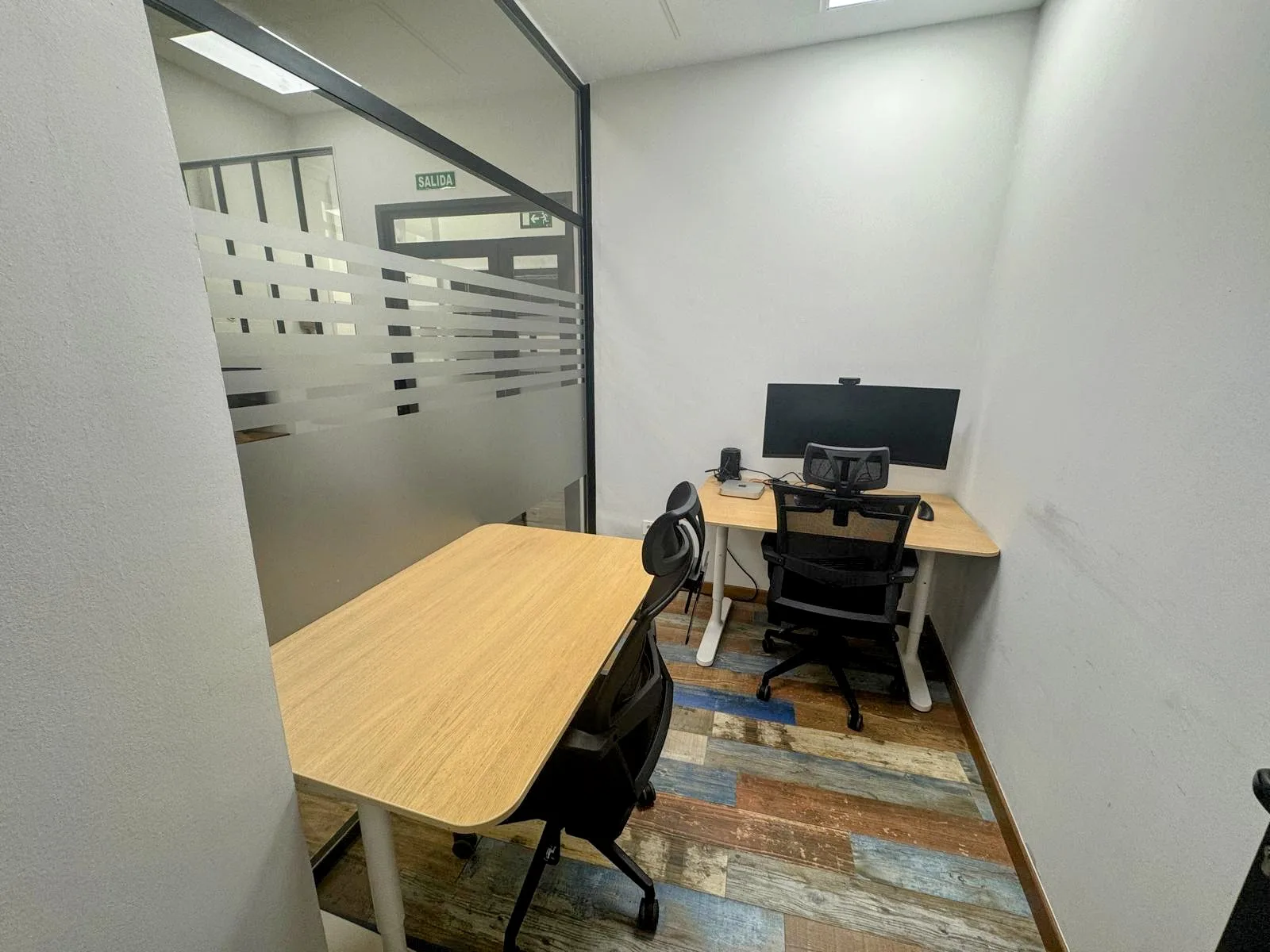 Bright private office with dual-monitor workstation
